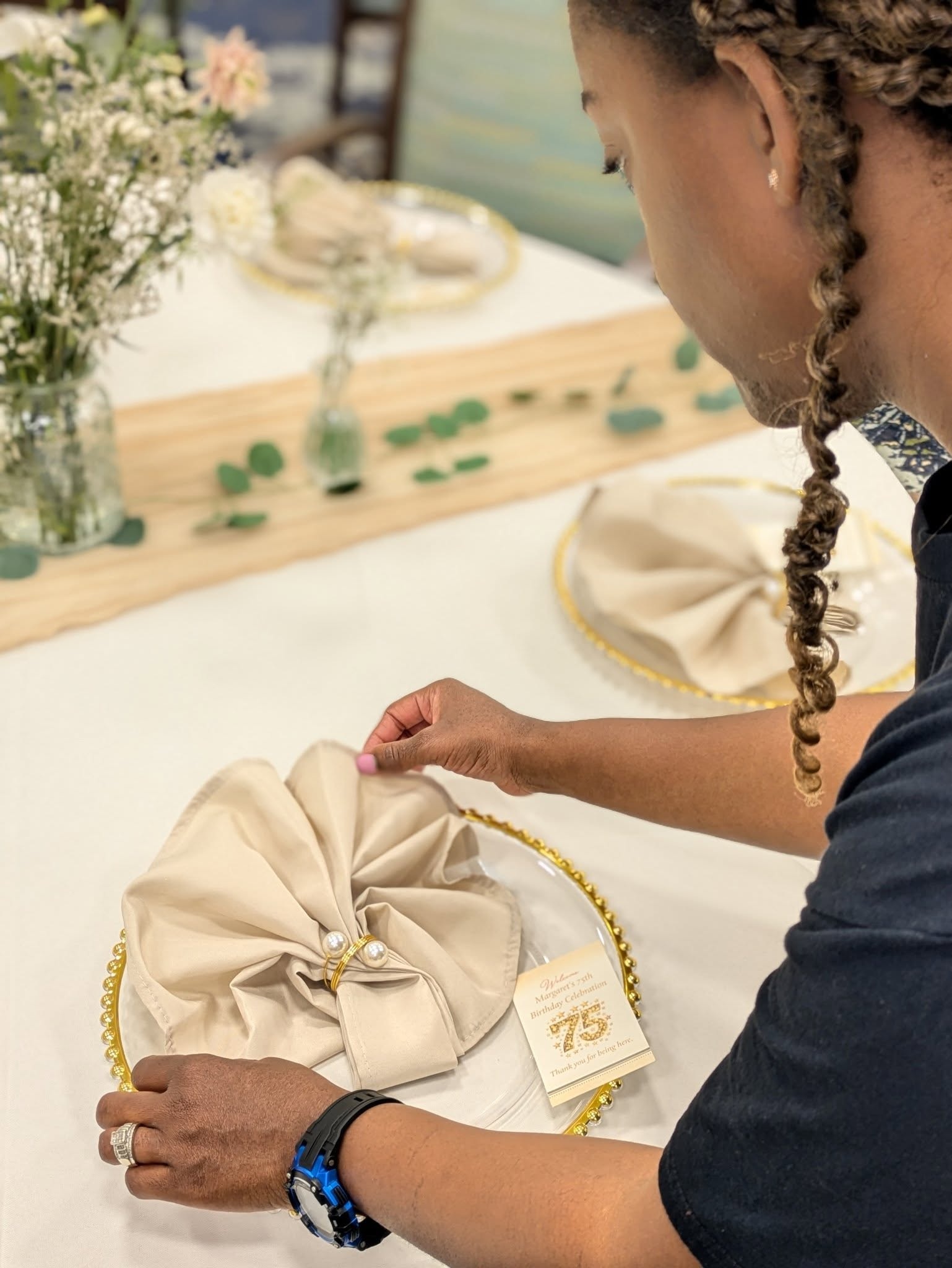 Castle Gardens ILM team setting custom wedding place settings and décor.